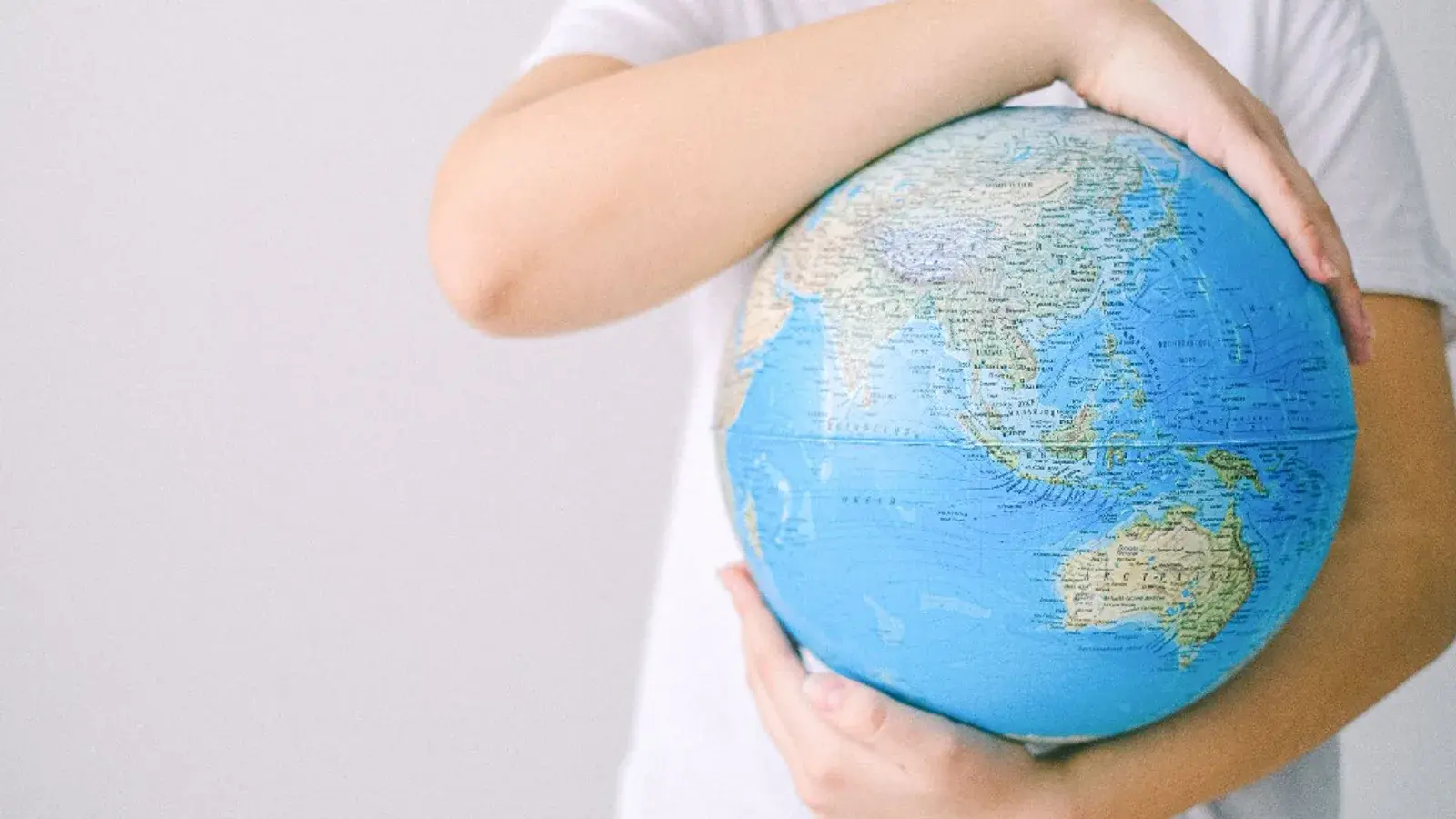 Person holding a globe, symbolising global human rights and country evidence work